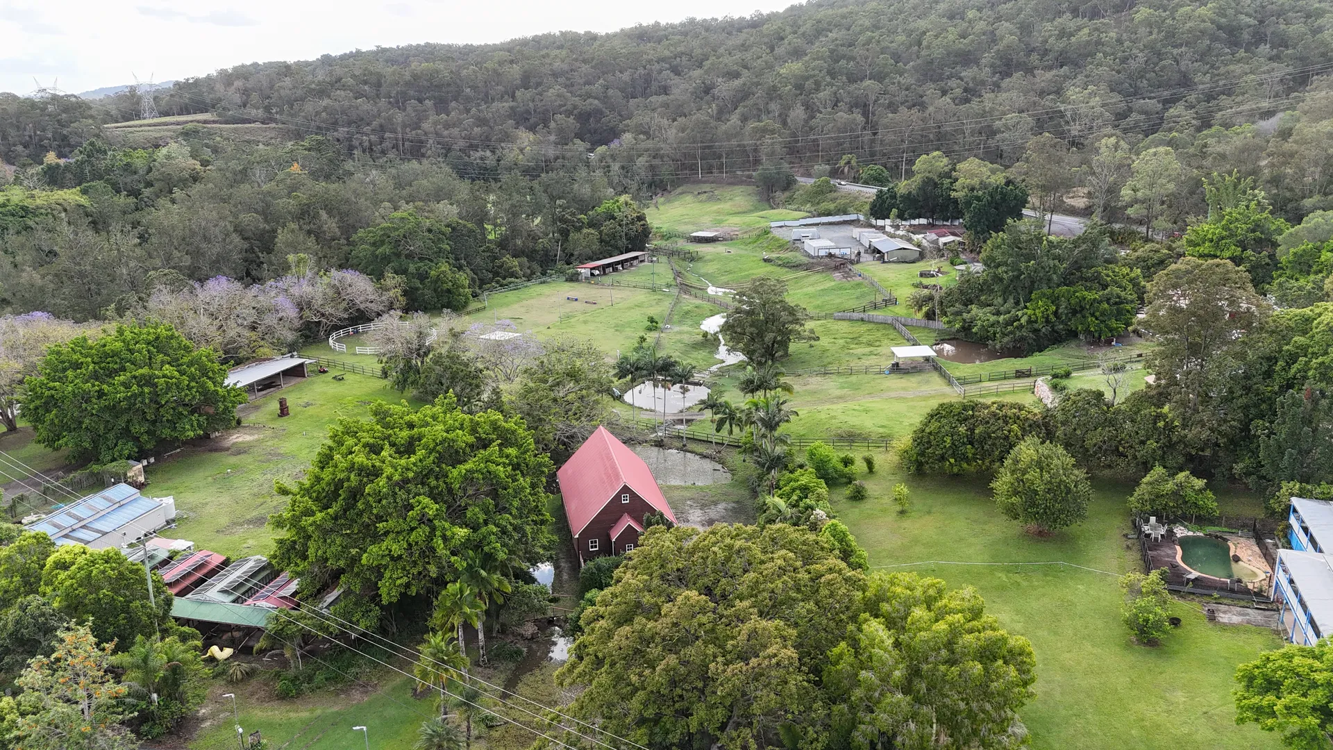 Aerial view of the Historic Rivermill property, paddocks, barn and gardens in the Coomera Valley