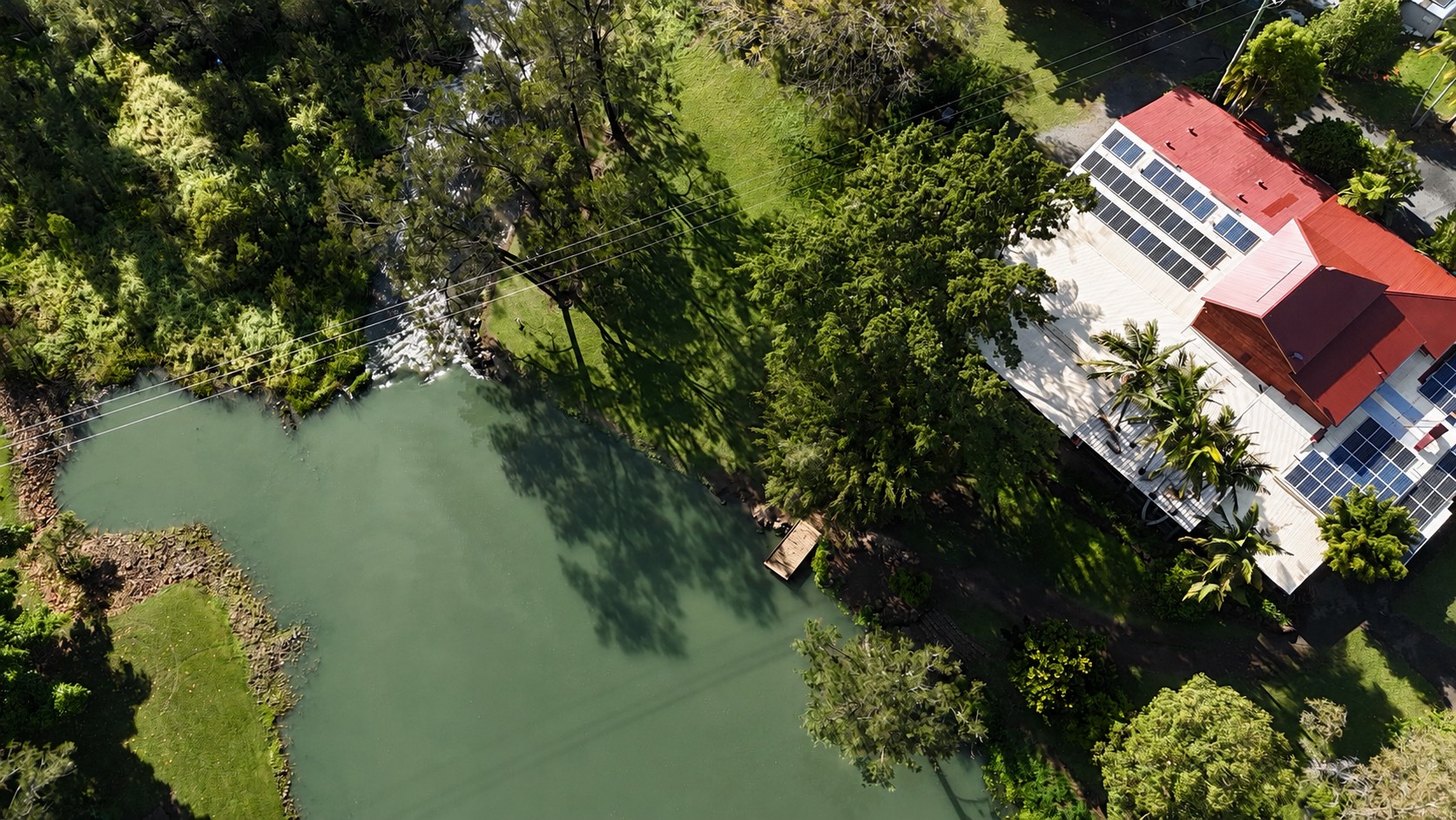 Aerial view of the Coomera River, the jetty and the riverside buildings at Historic Rivermill