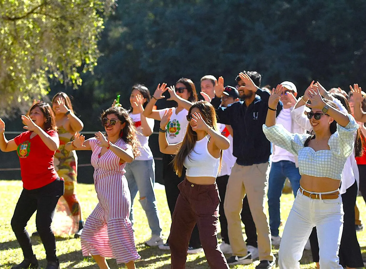 A corporate team day at Historic Rivermill, a group dancing together on the lawn