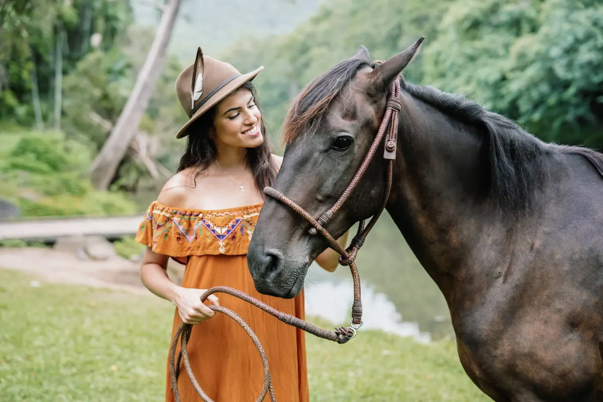 A visitor riding a Peruvian Paso horse at Historic Rivermill
